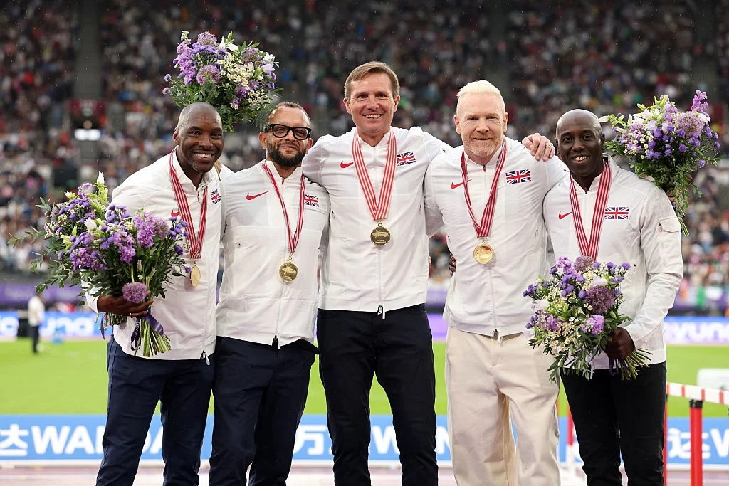 LONDON, ENGLAND - JULY 19: Former athletes of the Men's 4x400m Relay Great Britain team, Mark Richardson, Jamie Baulch, Roger Black, Iwan Thomas and Mark Hylton, pose for a photo with their gold medals during a special ceremony recognising their elevation from Silver for the 1997 World Athletics Championships at the Novuna London Athletics Meet, part of the 2025 Diamond League at London Stadium on July 19, 2025 in London, England. (Photo by Julian Finney/Getty Images)